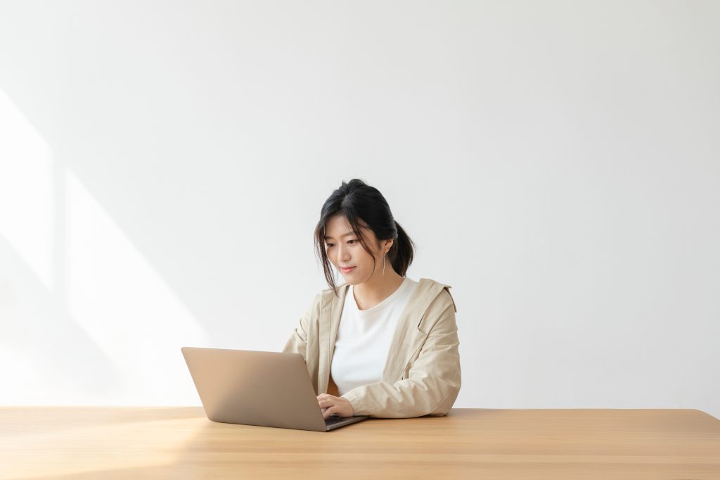 Asian woman at home using a laptop